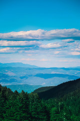 Beautiful view on the high green mountains peaks, on the blue sky background. Alpine Mountain hiking paradise landscape, no people.