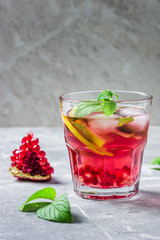 Delicious pomegranate mojito cocktail. Selective focus, space for text. 