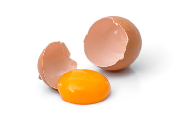 egg yolk in egg shell, cracked egg white isolated on white background - obrazy, fototapety, plakaty