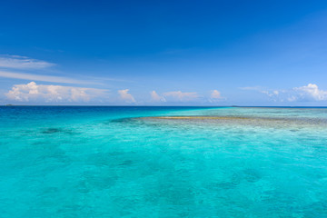 Colorful photo of Maldives atolls and deep blue sea