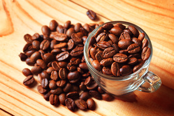 coffee beans in cup on wooden