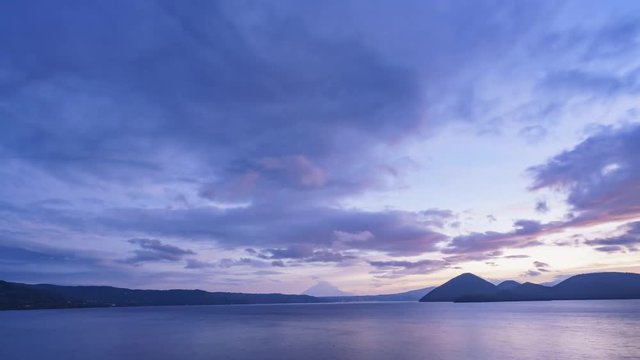 Sunrise motion timelapse of the famous Lake Toya with Mount Yotei at Hokkaido, Japan