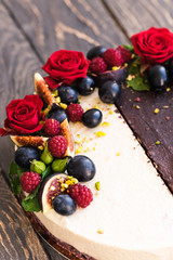 Two cakes in one, half chocolate, half vanilla coconut, decorated with roses and fruits. Dessert food photography. Yin yang concept.