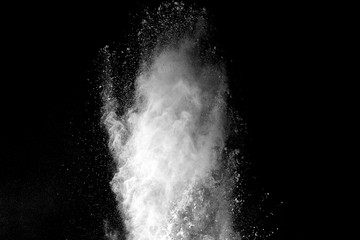 Explosion of white dust on black background.