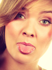 Closeup portrait of woman sticking tongue out