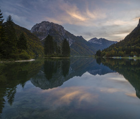 romantic sunset over a mountain lake in the Italian alps, Lago di Predil