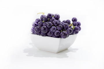 Raw dark grapes isolated on white background.