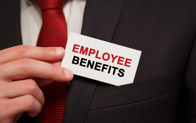 Businessman putting a card with text Employee Benefits in the pocket