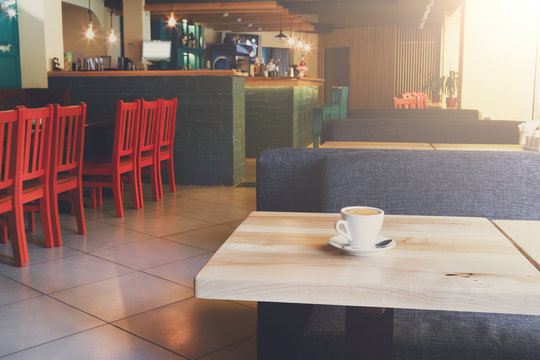 Modern restaurant interior, coffee cup on table