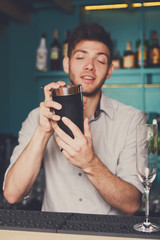 Bartender shaking and mixing alcohol cocktail