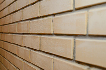 beige brick wall at an angle from the side