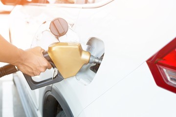 Man handle refilling the car with fuel at the refuel station