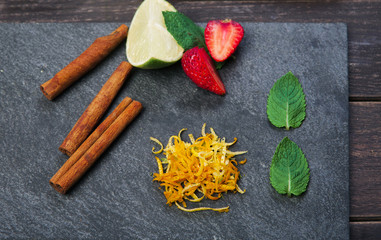 Healthy food top view, orange, strawberry and cinnamon