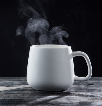 Steaming Coffee Cup With Smoke On Black Background