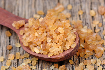 Crystal beige sugar in a spoon