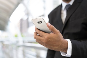 close up of businessman using telephone to contact the job. or Business man Contact Customer.