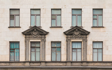 Fototapeta na wymiar Several windows in a row on facade of urban apartment building front view, St. Petersburg, Russia