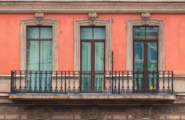 Fototapeta na wymiar Three windows in a row and balcony on facade of urban apartment building front view, St. Petersburg, Russia