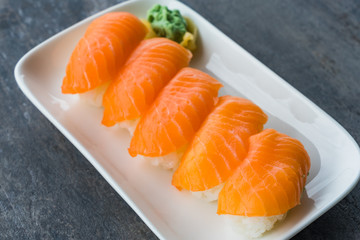 Fresh Japanese Salmon Sushi in white dish with Wasabi