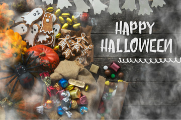 Naklejka premium Funny delicious ginger biscuits for Halloween shape ghost and skeleton with pumpkins and sweets. holiday text 