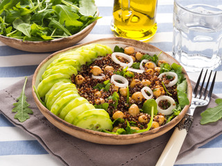 Quinoa salad bowl with cucumbers, chickpeas, onions, arugula. Light protein healthy dinner lunch