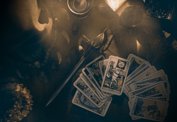 Tarot card / View of tarot card on the table under candlelight. Dark tone. - obrazy, fototapety, plakaty