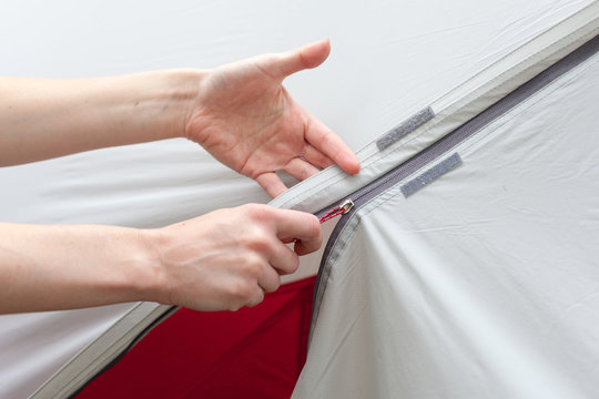 Girl Hand Unzip The Entry Of Camping Tent On Rainfly