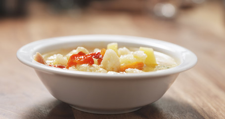 cauliflower soup in bowl on wood table