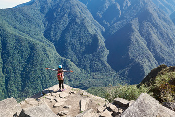 Woman stand on mountain cliff