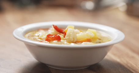 cauliflower soup in bowl on wood table