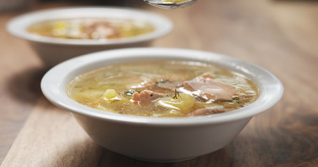 closeup fish soup with salmon on wood table