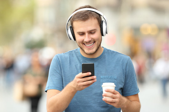 Happy man walking listening to music