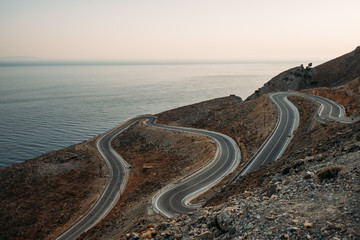 Crete / Greece, serpentine mountain road at sunset