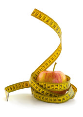 red apple wrapped with yellow centimeter tape