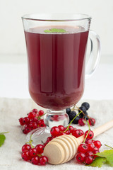 warming berry drink, tea, mors, red currant berries on a white background. © ytochka89