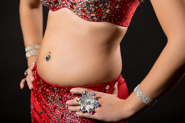 Image of belly dancer on black background.