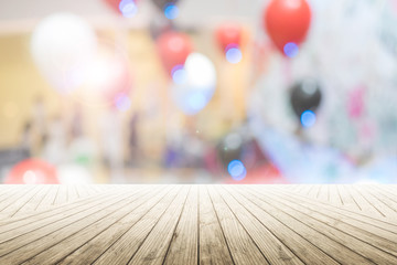 Empty wooden table with party in wedding background blurred.