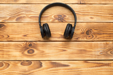 Stereo headphones on wooden background