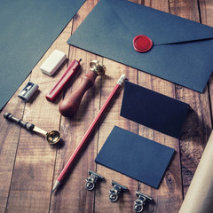 Photo of blank black stationery set on wood background. Vintage corporate ID template. Responsive...