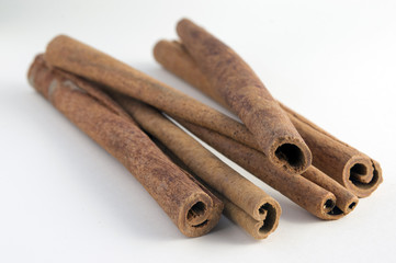 Fresh raw cinnamon sticks isolated on white background