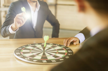 Business ,finance and marketing concept. Businessman holding a darts aiming at the target center...