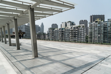 Panoramic skyline and buildings with empty concrete square floor