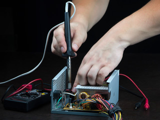 Repair of electronics with a soldering iron.