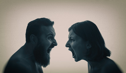 A man and a woman scream at each other. The concept of a family quarrel, violence, misunderstanding.