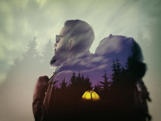 Photo of stylish bearded traveler looking into the distance. Double exposure, beautiful mountain...