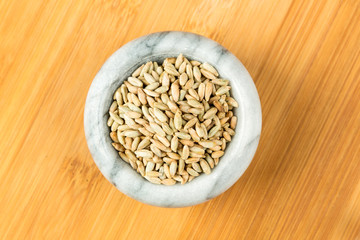 Rye berry grains on a wood background