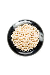Toasted couscous grains isolated on a white background