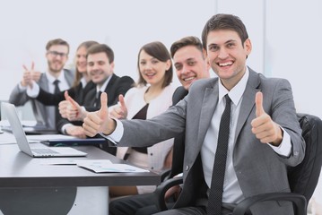 Fototapeta premium successful business team showing thumbs up