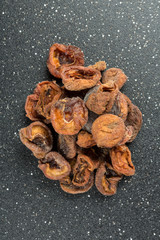 Organic dried apricots on a black background