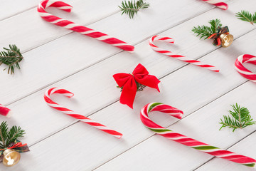 Christmas background with candies and small balls on wood